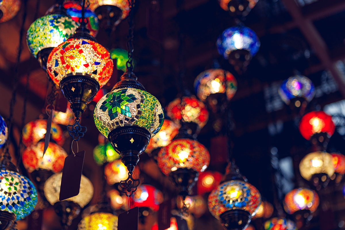 Middle Eastern lamps of different colors hanging in bazaar in Turkey